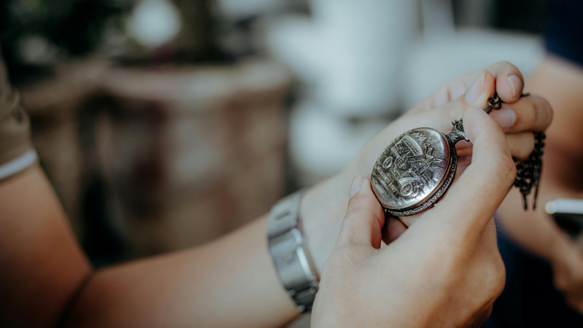 A close-up image of a person holding a vintage pocket watch, possibly symbolizing inheritance or sentimental items passed down after a deceased person’s estate is settled—relevant in the context of an insolvent estate where not all assets may be distributed to family members